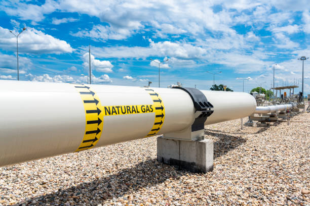 istock Gas pipeline at the compressor station site with the designation of the transported medium and the direction of flow 2174602467