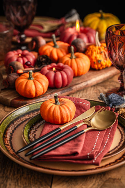 istock Festive Thanksgiving table setting with pumpkins and candles in orange and red tone 2174604786