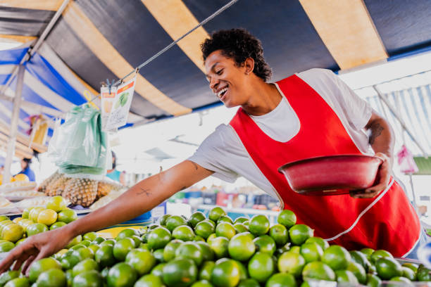 istock Vendor picking limes in a street market 2174605592
