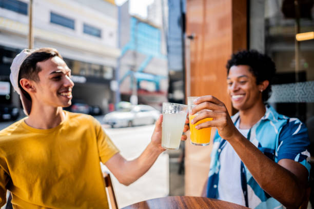 Young friends toasting on an outside restaurant table
