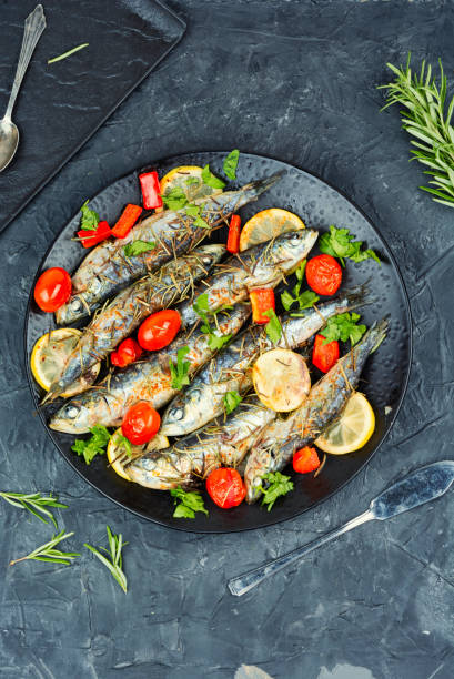 istock Whole roasted fish with lemon slices and herbs. 2174610413