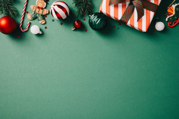 istock Festive Christmas decor on green backdrop with gingerbread man, candy canes, and ornaments. Perfect for holiday designs and marketing materials. High-quality, vibrant, and seasonal 2174610591