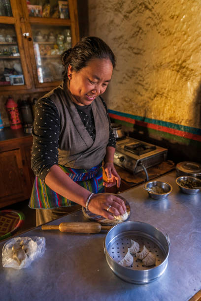 istock Tibetan woman preparing momos, Upper Mustang, Nepal 2174610889