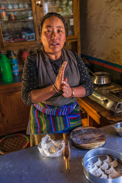 istock Tibetan woman preparing momos, Upper Mustang, Nepal 2174610920