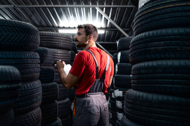 istock Doing inventory of new car tires inside warehouse. 2174610938