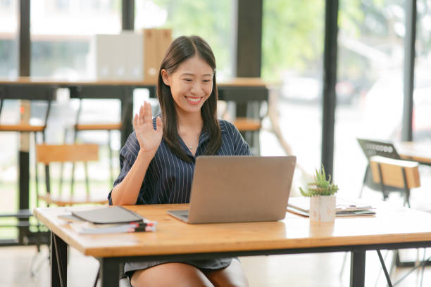 istock Two women work on laptops, edit work, and talk about paperwork and graphs. 2174611224