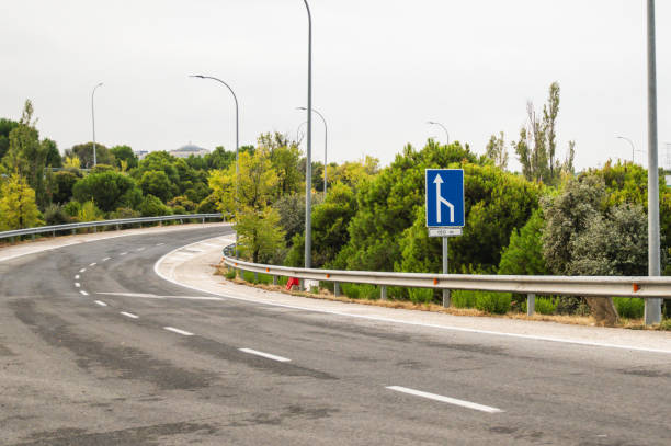 On a highway we see the sign indicating : End of lane for traffic (S-52), passing the race to a single lane.