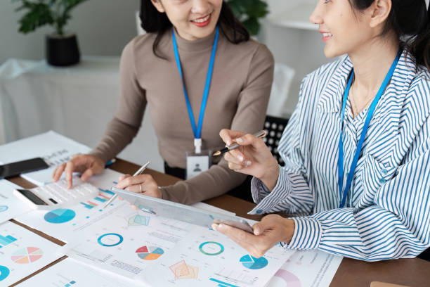 istock Professional Business Meeting with Colleagues Analyzing Financial Data and Charts in a Modern Office Setting 2174614648