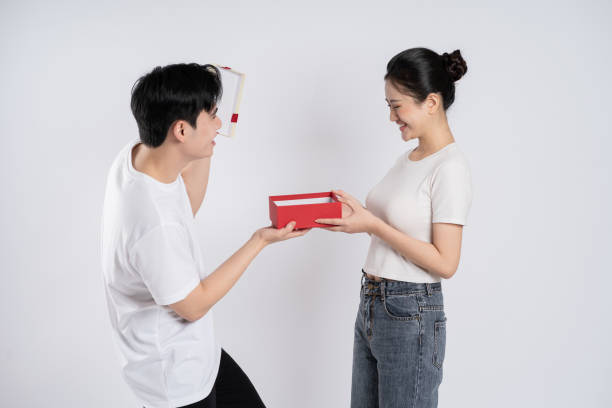 point of view Happy asian couple receive packing parcel after online shopping and opening a delivery box at home