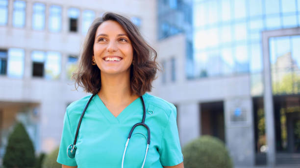 istock Beautiful, young doctor on a break outside 2174620714