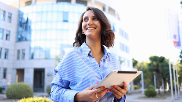 istock Corporate lady using a tablet on the street 2174620891
