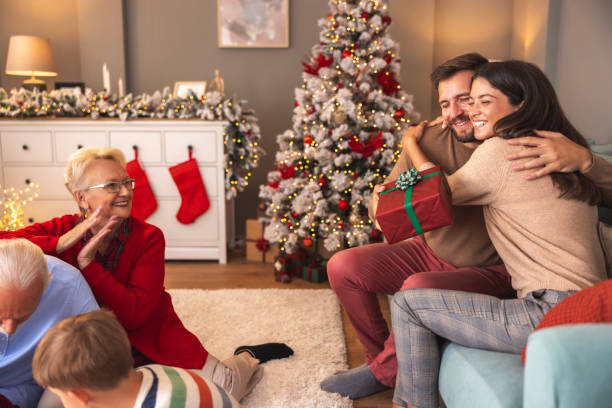 istock Husband and wife exchanging Christmas presents 2174623913