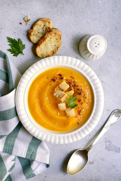 istock Delicious pumpkin soup with croutons. Top view with copy space. 2174624215
