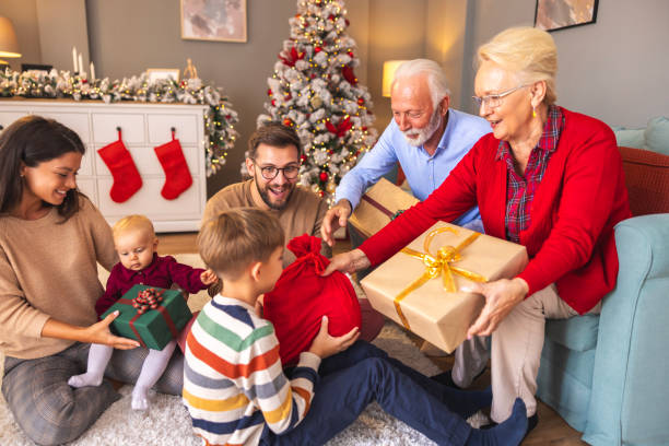 istock Happy multi-generation family exchanging Christmas presents at home 2174624534