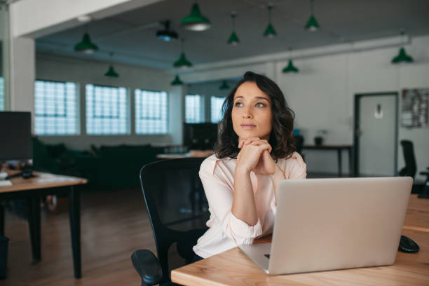istock Young businesswoman thinking about work while sitting at her desk 2174624679