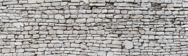 istock stone wall made of old cobblestones, gray brickwork background 2174625432