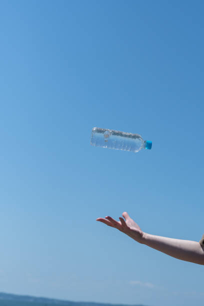Person holding a plastic bottle of water