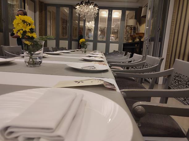 istock long dining table and plates and chairs in a restaurant. 2174628642