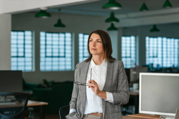 istock Businesswoman standing in an office looking deep in thought 2174628710