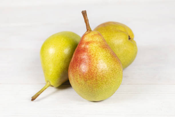 istock Pears on white wooden background 2174629392
