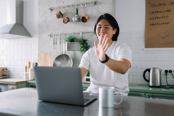 istock Young Asian man making a video call on a laptop at home 2174632827