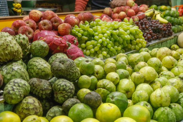 A vibrant market stall showcasing a diverse array of fresh fruits, including watermelons, bananas, avocados, and more, highlighting the colorful and abundant produce found in Baguio City, Philippines.