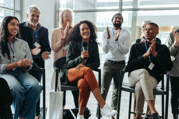 istock Happy professionals enjoying a lively panel discussion at a corporate event 2174637611