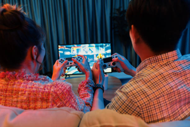 istock Couple controlling joystick playing fighting competition game on tv. Infobahn. 2174638970