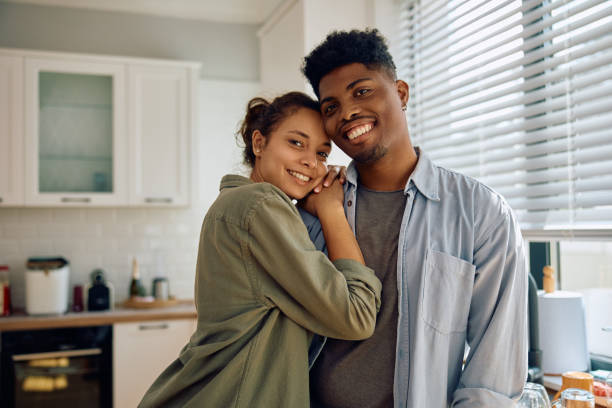 istock Young mixed race coupe in love in the kitchen looking at camera. 2174639899