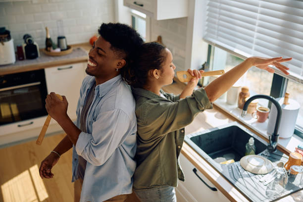 istock Young carefree couple having fun while doing dishes in the kitchen. 2174639957
