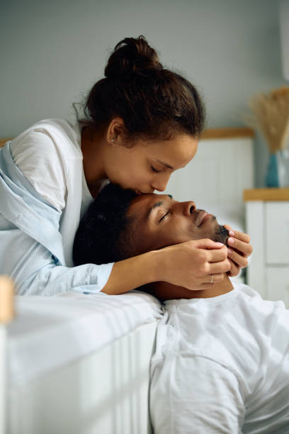 istock Affectionate woman kissing her boyfriend in forehead. 2174640913