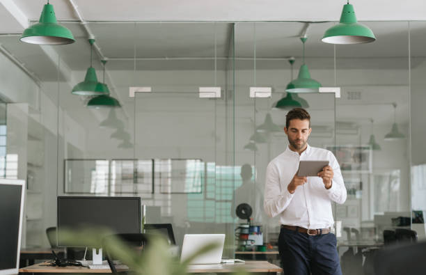 istock Focused young businessman working on a tablet in an office 2174640996