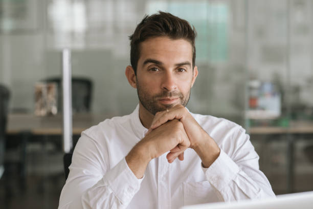 istock Focused young businessman sitting alone in a modern office 2174641024
