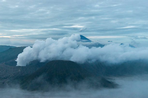 Mount bromo volcano on java island in indonesia is seen erupting smoke and ash at dawn