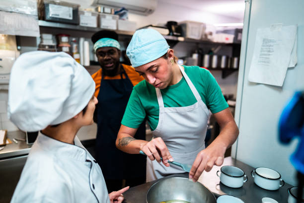 Transgender woman making a cake during cooking class at bakery kitchen