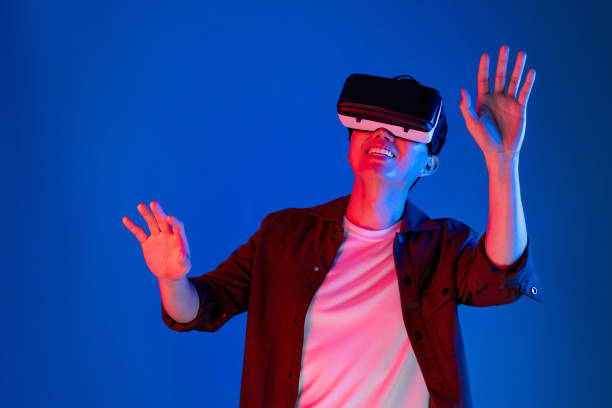 istock Asian man looking VR turn to metaverse pointing slide research. Contrivance. 2174643776
