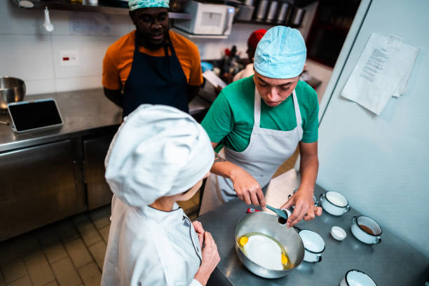 istock Transgender woman making cake with chef at bakery kitchen 2174644024