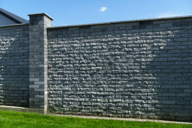 istock stone fence and green grass lawn as background 2174644045
