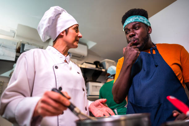 istock Student and chef tasting food at bakery kitchen 2174644082