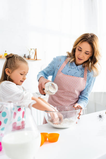 istock A joyful mother and daughter bond in a bright kitchen while baking together 2174645355