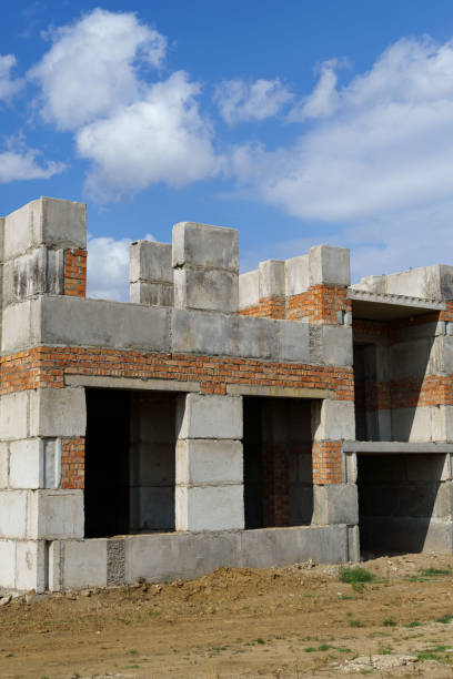 istock a construction site with a house under construction against the sky 2174645646