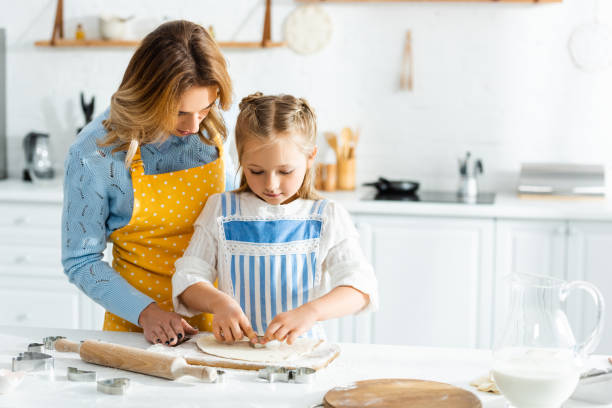 istock A mother and daughter bond while happily baking in a warm, cheerful kitchen 2174646777