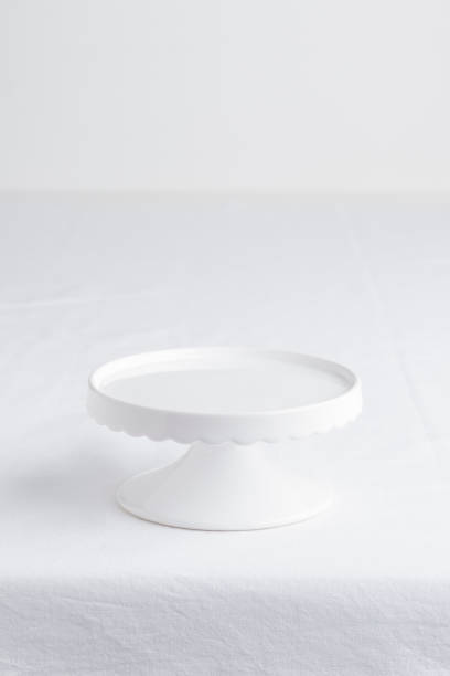istock Empty tableware - white plate cakestand on white table as a background for a dessert vertical photo with a copy space, food mokup 2174649445
