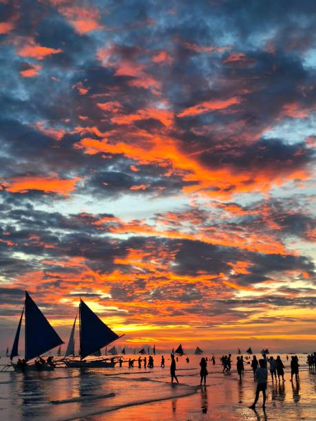 Magnet Boracay sunset highlighting paraw (sailboat) and tourists.