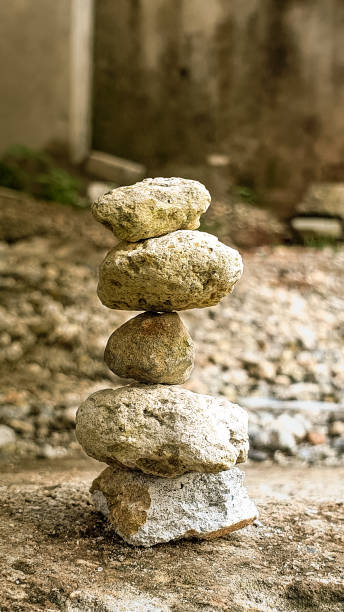 istock balanced stacked stones. pebbles on the ground. 2174656255