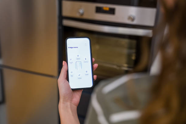istock Woman using smart home application controlling smart refrigerator from smartphone 2174658380