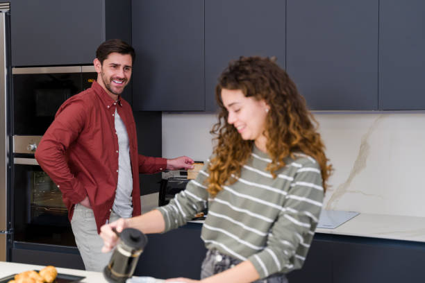 istock Young couple preparing breakfast in modern kitchen together 2174658395