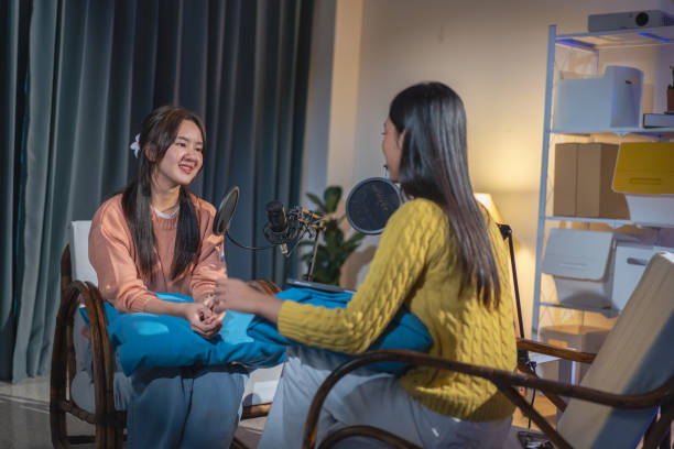 istock Two Asian women having a fun conversation during a podcast. 2174659166