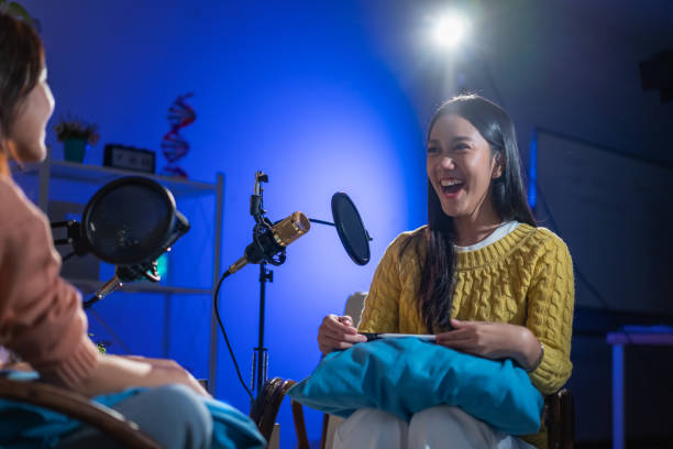 istock Two Asian women having a fun conversation during a podcast. 2174659178
