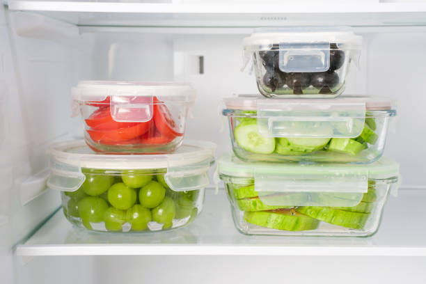 istock Glass boxes with vegetables and fruits in refrigerator front view, concept food storage. 2174659225